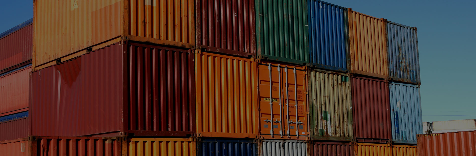 Image of freight containers stacked in colorful rows.